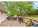 Wooden deck with grill, table, chairs and backyard view at 984 Ridgecrest Se Dr, Smyrna, GA 30080