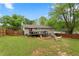 Fenced backyard featuring a deck with an umbrella, a hammock, garden beds, and an outdoor grill at 984 Ridgecrest Se Dr, Smyrna, GA 30080