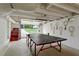 Finished basement with garage door access and ping pong table at 984 Ridgecrest Se Dr, Smyrna, GA 30080