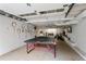 Finished basement with painted walls, ping pong table, and ample space at 984 Ridgecrest Se Dr, Smyrna, GA 30080