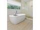 Modern bathroom with soaking tub and glass-enclosed shower, offering a spa-like experience at 984 Ridgecrest Se Dr, Smyrna, GA 30080