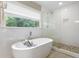 Modern bathroom with soaking tub and glass-enclosed shower, offering a spa-like experience at 984 Ridgecrest Se Dr, Smyrna, GA 30080