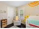 Cozy Bedroom with cheerful decor and a comfortable chair, perfect for a new baby at 984 Ridgecrest Se Dr, Smyrna, GA 30080
