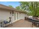 Outdoor deck with a grill, table, seating and access to the backyard, perfect for entertaining at 984 Ridgecrest Se Dr, Smyrna, GA 30080