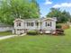 Charming gray two-story home with landscaped front yard and welcoming front porch swing at 984 Ridgecrest Se Dr, Smyrna, GA 30080
