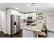 Well-appointed kitchen with stainless appliances, granite countertops, and barstool seating at 984 Ridgecrest Se Dr, Smyrna, GA 30080