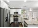 Well-lit kitchen featuring stainless steel appliances, granite countertops, and white cabinetry at 984 Ridgecrest Se Dr, Smyrna, GA 30080