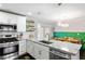 Bright kitchen showcasing stainless steel appliances, granite countertops, and eat-in dining area at 984 Ridgecrest Se Dr, Smyrna, GA 30080