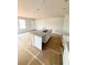 Bright kitchen with a center island featuring a stainless steel sink at 11606 E Lovejoy Rd, Hampton, GA 30228