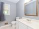 Bathroom with a large mirror, window, and a white sink and toilet at 1463 Shadowrock Hts, Marietta, GA 30062