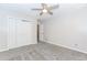 This bedroom has neutral walls, carpet flooring, a ceiling fan and a closet at 1463 Shadowrock Hts, Marietta, GA 30062