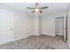This bedroom has neutral walls, carpet flooring, a ceiling fan and two doors at 1463 Shadowrock Hts, Marietta, GA 30062