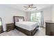 This bedroom has neutral walls, carpet flooring, a ceiling fan and a window at 1463 Shadowrock Hts, Marietta, GA 30062