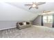 This bonus room has neutral walls, carpet flooring, two ceiling fans and a sofa at 1463 Shadowrock Hts, Marietta, GA 30062
