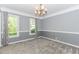 Dining room with gray walls, carpet, chandelier, and natural light from large windows at 1463 Shadowrock Hts, Marietta, GA 30062