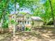 Two-story home with screened porch and lush greenery, offering serene backyard views at 1463 Shadowrock Hts, Marietta, GA 30062