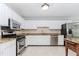 Bright kitchen with white cabinets, granite countertops, stainless steel appliances, and tiled backsplash at 1463 Shadowrock Hts, Marietta, GA 30062