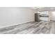 Basement kitchenette features stainless steel refrigerator, white cabinets and countertops, and wood-look flooring at 1463 Shadowrock Hts, Marietta, GA 30062