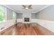 Bright living room with hardwood floors, a white brick fireplace, large windows, and elegant white trim at 1463 Shadowrock Hts, Marietta, GA 30062