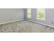 Inviting living room featuring neutral gray walls, plush carpeting, and sunlit windows with views of the outdoors at 1463 Shadowrock Hts, Marietta, GA 30062
