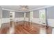 Bright living room with hardwood floors, elegant trim, large windows, and a doorway leading to the kitchen at 1463 Shadowrock Hts, Marietta, GA 30062