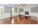 Bright living room with hardwood floors, a white brick fireplace, large windows, and elegant white trim at 1463 Shadowrock Hts, Marietta, GA 30062