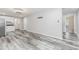 Basement living space features wood-look floors, neutral paint, inset lighting, and a kitchenette and bathroom at 1463 Shadowrock Hts, Marietta, GA 30062