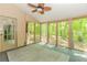 Sunroom features many screened windows with wooded view, door to the exterior, and a ceiling fan at 1463 Shadowrock Hts, Marietta, GA 30062