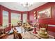 Warm dining room boasting red accent wall, bright windows and an inviting atmosphere at 436 Berkshire Pl, Fairburn, GA 30213