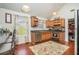 Eat-in kitchen with stainless steel appliances, wooden cabinets and a view of the dining area at 436 Berkshire Pl, Fairburn, GA 30213