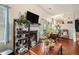 Cozy living room with fireplace, wood floors, and decorative furnishings at 436 Berkshire Pl, Fairburn, GA 30213