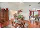 Spacious living room features hardwood floors, stylish decor and seamless flow to the dining area at 436 Berkshire Pl, Fairburn, GA 30213