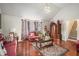 Bright living room with hardwood floors, vaulted ceiling, comfortable seating and staircase access at 436 Berkshire Pl, Fairburn, GA 30213