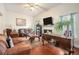 Spacious living room with wood floors, comfortable seating and a decorative fireplace at 436 Berkshire Pl, Fairburn, GA 30213