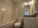 Clean bathroom with a shower-tub combo, granite vanity, and modern fixtures providing a relaxing space at 55 Barton Ln, Covington, GA 30016