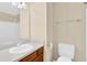 Bathroom featuring white fixtures, wooden cabinet and an overhead light at 6139 Keswick Row, Tucker, GA 30084
