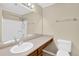 Standard bathroom with a white sink, a toilet, shower and large mirror over the sink at 6139 Keswick Row, Tucker, GA 30084