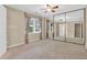 Bedroom featuring mirrored closet doors, a ceiling fan, and natural light from window at 6139 Keswick Row, Tucker, GA 30084