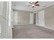 Spacious bedroom with neutral carpet, a ceiling fan, and natural light from the windows at 6139 Keswick Row, Tucker, GA 30084