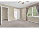 Bedroom with neutral walls and carpets featuring an ensuite bathroom and lots of natural light at 6139 Keswick Row, Tucker, GA 30084