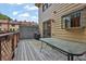 Wooden deck featuring glass-topped table, wood railings and building exterior at 6139 Keswick Row, Tucker, GA 30084