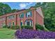 Brick townhouse with lush landscaping and inviting curb appeal at 6139 Keswick Row, Tucker, GA 30084