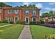 Inviting brick townhouse with lush green lawn and colorful purple landscaping at 6139 Keswick Row, Tucker, GA 30084