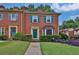 Charming brick townhouse with teal shutters, tidy landscaping, and inviting entryway at 6139 Keswick Row, Tucker, GA 30084
