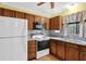 Functional kitchen with stainless steel sink, appliances, and wooden cabinetry at 6139 Keswick Row, Tucker, GA 30084