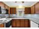 Functional kitchen with appliances, and wooden cabinets and neutral colored countertops at 6139 Keswick Row, Tucker, GA 30084
