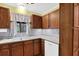 Kitchen area featuring stainless steel sink, appliances, and wooden cabinets and countertops at 6139 Keswick Row, Tucker, GA 30084