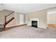 Cozy living room with fireplace, neutral carpet, and staircase at 6139 Keswick Row, Tucker, GA 30084