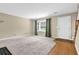 Bright and airy living room featuring neutral carpet, large window, and staircase at 6139 Keswick Row, Tucker, GA 30084