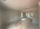 Unfinished living room featuring ample natural light. Construction phase at 25 Emerald Ln, Covington, GA 30014